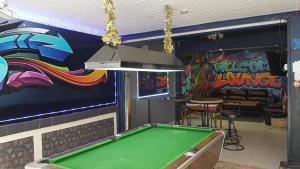 a pool table in a bar with a mural at Welcome Lounge in Jomtien Beach