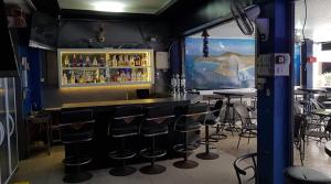 a bar in a restaurant with bar stools at Welcome Lounge in Jomtien Beach