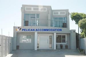a house with a sign that reads pelican association approximation at Pelican Accommodation Ottery in Cape Town