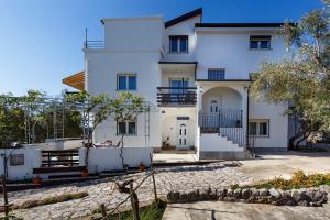 a large white house with a stone driveway at Apartments Zarko in Brzac