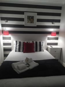 a bedroom with a bed with black and white stripes at FerhouseDreams-Praia in Nazaré