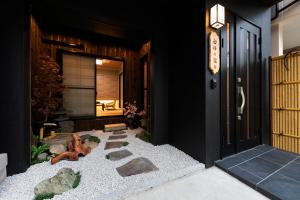 a front door of a home with a z garden at Shirakabanoyado - AOARASHI 白樺の宿 - 青嵐, 3mins walk to station! in Osaka +30 photos