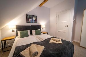 1 dormitorio con 1 cama grande y 2 toallas. en Sielanka - Dom na Mazurach, en Cierzpięty