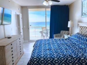 a bedroom with a bed and a view of the ocean at Majestic Resort 505 with RESERVED parking on 3rd Floor Walk-Over in Panama City Beach