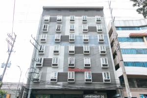 a tall building with a red blaze sign on it at RedDoorz Plus @ Kamuning Quezon City in Manila