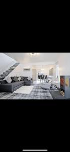 a living room with a couch and a table at Contemporary Highland House close to town and Ben Nevis in Fort William