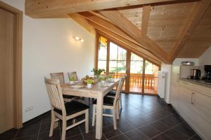 a kitchen and dining room with a table and chairs at Ferienwohnung Fagerer in Piding