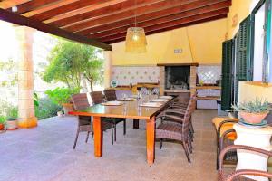 a wooden table and chairs on a patio at Finca Son Rossinyol 128 by Mallorca Charme in Sineu