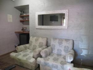 a living room with a couch and a tv at Critchley Hackle Dullstroom Leisure in Dullstroom