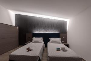 A bed or beds in a room at Hotel Da Si-Si