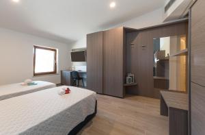 A bed or beds in a room at Hotel Da Si-Si