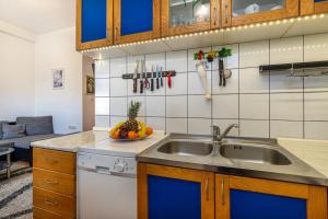 a kitchen with a sink and a counter at Apartments Grof in Selce +18 photos
