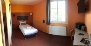 a small bedroom with a bed and a window at Hôtel Particulier LE MAS DES MARAIS in Machecoul