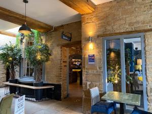 a restaurant with a table and chairs in a building at The Deeping Stage in Market Deeping