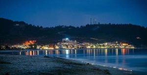 a view of a lake at night with a city at House Chrysoula Mitsokopi in Sarti