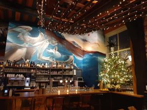 a bar with a christmas tree in a room at Hector Zierikzee in Zierikzee