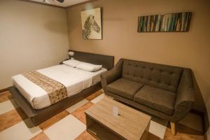 Postel nebo postele na pokoji v ubytování DG Grami Hotel