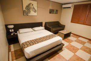 Postel nebo postele na pokoji v ubytování DG Grami Hotel