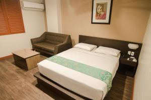 Postel nebo postele na pokoji v ubytování DG Grami Hotel