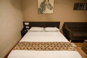 Postel nebo postele na pokoji v ubytování DG Grami Hotel