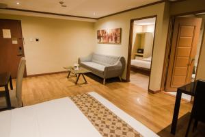 Postel nebo postele na pokoji v ubytování DG Grami Hotel
