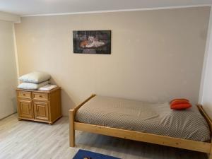 a small bedroom with a bed and a night stand at Ferienwohnung Limes in Aalen