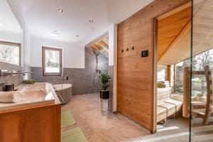 a bathroom with a sink and a bath tub at Brandhof in Ramsau am Dachstein +265 photos