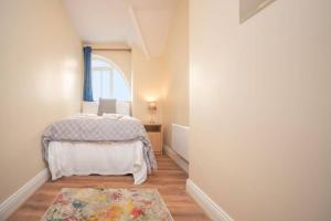 a small bedroom with a bed and a window at Latin Quarter Luxury in Galway