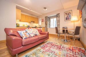 a living room with a leather couch and a table at Latin Quarter Luxury in Galway