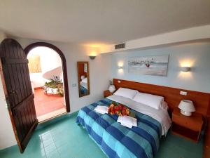 a bedroom with a bed with flowers on it at Casa Vacanze Elianto in Anzio