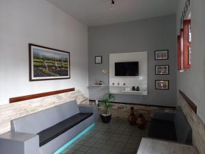 - un salon avec un canapé et une télévision dans l'établissement Hotel Lucena, à Guarabira