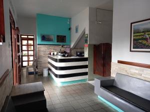 a restaurant with a counter in the middle of a room at Hotel Lucena in Guarabira
