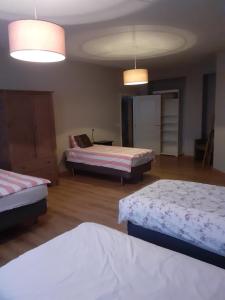 a hotel room with two beds and two tables at Wenceslas Cobergher Appartement II in Boutersem