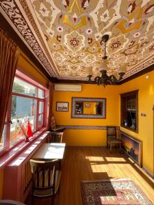 a room with a ceiling with a table and chairs at Cheers Vintage Hostel in Istanbul