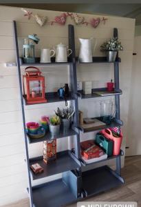 a shelf with pots and pans and other items on it at Midleydown Luxury Glamping in Exeter