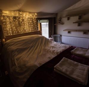 En eller flere senge i et værelse på Midleydown Luxury Glamping