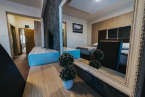 a room with a mirror and a bed and a bedroom at Hotel Brcko Gas Prijedor in Prijedor