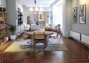 a living room with a table and chairs in it at Savoy Hotel in Copenhagen