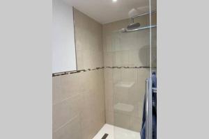 a bathroom with a shower with a glass door at Idyllic Self Contained Annex Flat in Eaton in Cringleford +8 photos