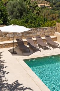 a group of chairs and an umbrella next to a swimming pool at Cas Suis 7 in Campanet