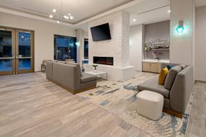 a living room with two couches and a fireplace at Staybridge Suites - Long Beach Airport, an IHG Hotel in Long Beach