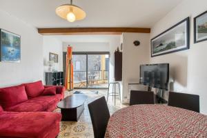 a living room with a red couch and a table at Appartement de 2 chambres avec terrasse et wifi a Saint Jacut de la Mer in Saint-Jacut-de-la-Mer