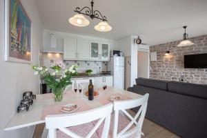 a kitchen and living room with a table and a couch at APARTMANI Mirona - Tučepi in Tučepi