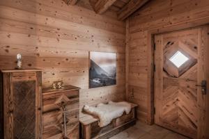 a log cabin with a bench and a door at Benglerwald Berg Chaletdorf in Bach +243 photos