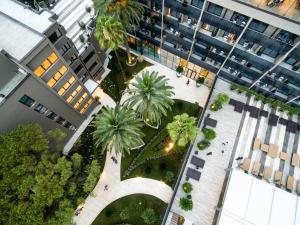 an overhead view of a courtyard with palm trees and buildings at Palmon Bay Hotel & Spa in Herceg-Novi
