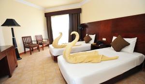 Ένα ή περισσότερα κρεβάτια σε δωμάτιο στο Royal Brayka Beach Resort