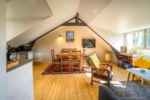 a kitchen and living room with a table and chairs at Le Prieuré Saint-Malo de Dinan in Dinan