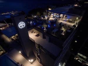 a building with acedes benz sign on it at night at Palmon Bay Hotel & Spa in Herceg-Novi