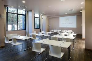 a dining room with white tables and white chairs at Palmon Bay Hotel & Spa in Herceg-Novi