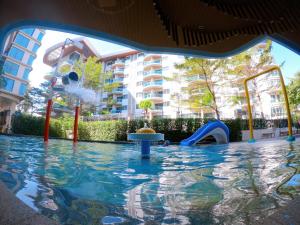a pool with a water park with a water slide at Sonrisa Srirachaที่พักติดทะเล in Si Racha